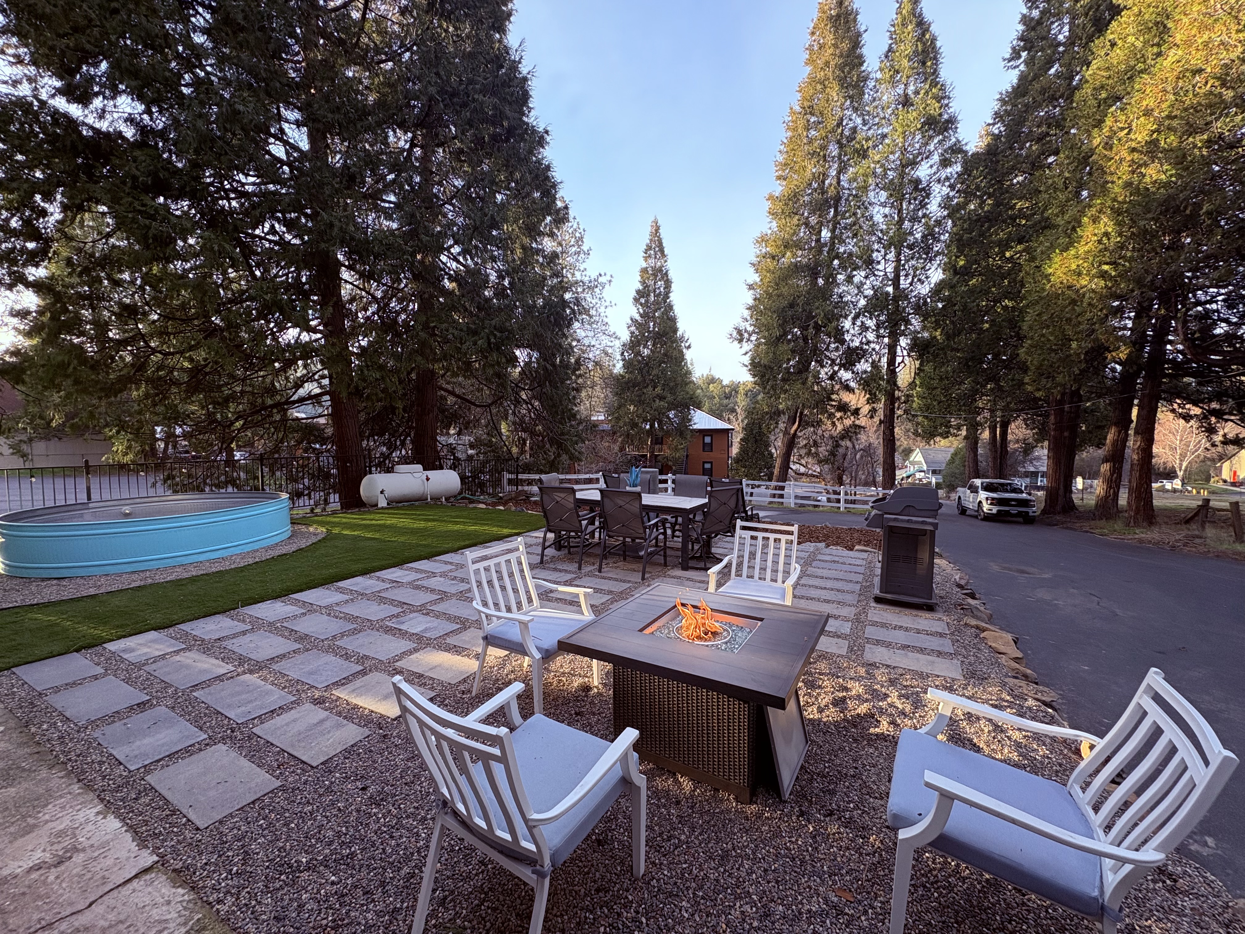 Vana Haven outdoor patio with fire pit surrounded by tall pines